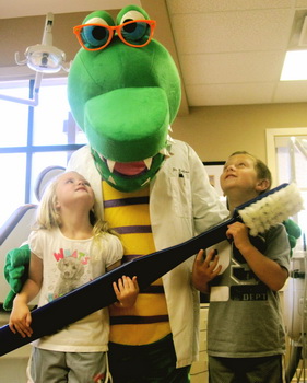 Alligator and two kids with toothbrush